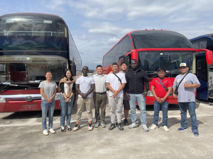 Receiving clients for a tour of the bus factory.png